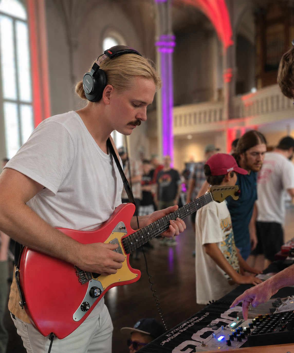 Player trying a Lewis guitar in a live music setting